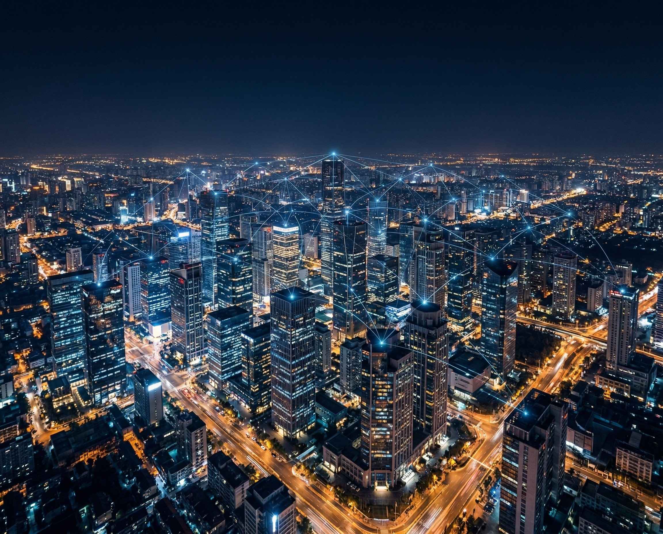 Aerial night view of a modern city skyline with glowing blue data connectivity nodes overlaid across buildings and intersections, representing real-time data infrastructure at scale